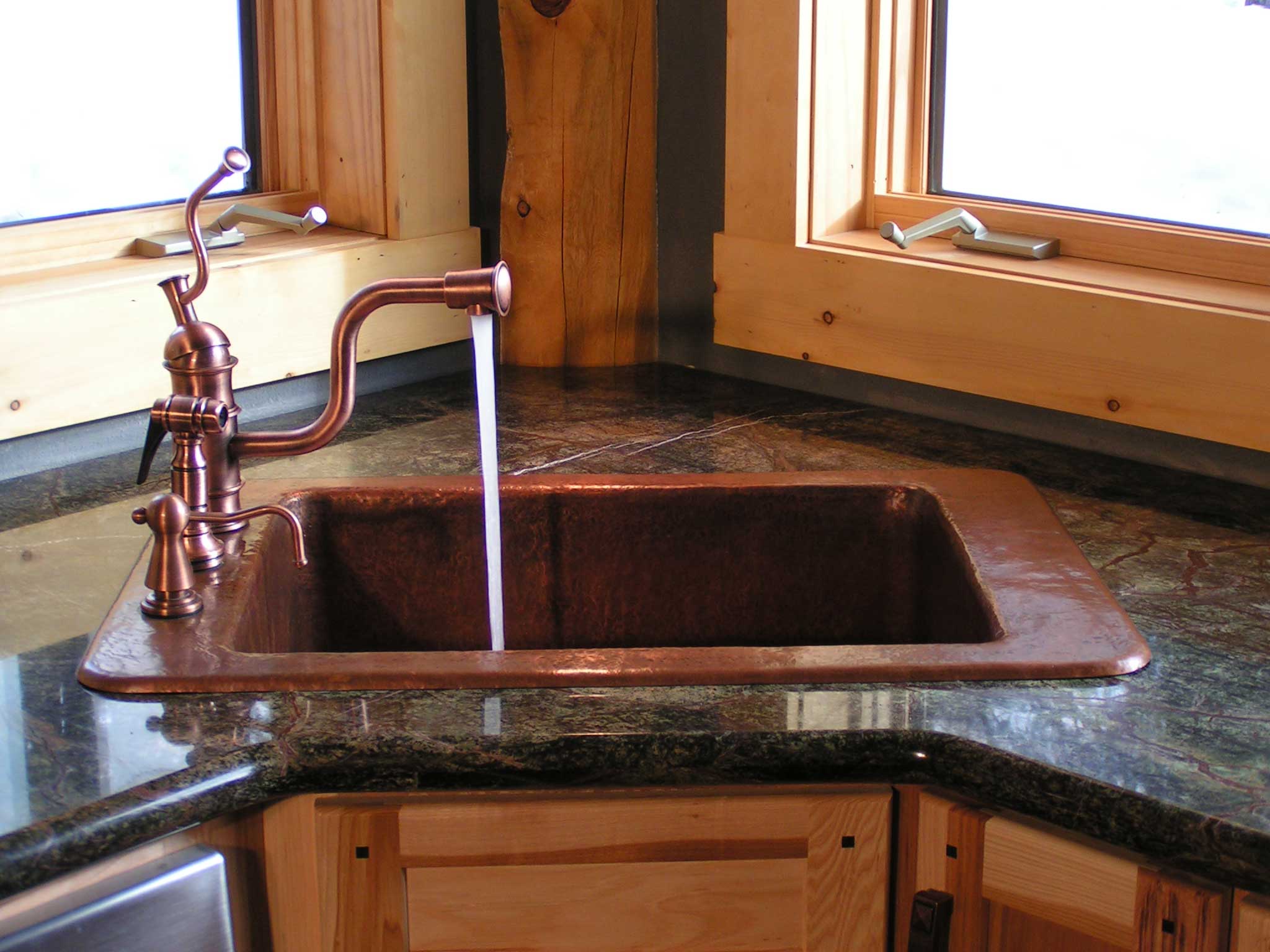 copper sink black counters kitchen